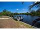 Sunny backyard with a waterfront dock, seating, and beautiful water views at 4238 Gardner Dr, Port Charlotte, FL 33952