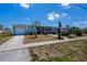 Charming single-story home with a well-maintained lawn, complemented by a lush palm tree at 4238 Gardner Dr, Port Charlotte, FL 33952