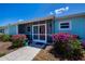 Charming home exterior featuring a screened-in porch, and beautiful bougainvillea at 4238 Gardner Dr, Port Charlotte, FL 33952