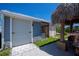 Side view of the home showing garage, storage, tiki hut and stone accents at 4238 Gardner Dr, Port Charlotte, FL 33952