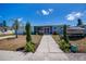 Attractive single-story home with a boat parked on the side, complemented by flowering bushes at 4238 Gardner Dr, Port Charlotte, FL 33952