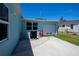 View of the home's exterior, including the garage, equipment, and fence line at 4238 Gardner Dr, Port Charlotte, FL 33952