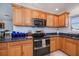 Cozy kitchen offering stainless steel appliances, granite countertops and custom cabinetry at 4238 Gardner Dr, Port Charlotte, FL 33952
