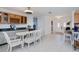 Bright kitchen and dining area with tiled floors and white wooden table and chairs at 4238 Gardner Dr, Port Charlotte, FL 33952