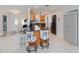 Open kitchen with breakfast bar, gray cabinets and access to dining and living room at 4238 Gardner Dr, Port Charlotte, FL 33952