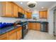 Well-equipped kitchen with stainless steel appliances, granite countertops, and ample cabinetry at 4238 Gardner Dr, Port Charlotte, FL 33952