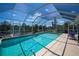 The screened-in pool with waterfront views is the perfect space to enjoy outdoor living at 4238 Gardner Dr, Port Charlotte, FL 33952