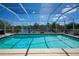 Screened-in pool with clear blue water, and lovely waterfront views, surrounded by mature foliage at 4238 Gardner Dr, Port Charlotte, FL 33952