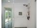 Bright glass shower with shower head and a white tiled wall at 4238 Gardner Dr, Port Charlotte, FL 33952