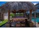 View of the home's tiki hut featuring bar seating, and views of the water at 4238 Gardner Dr, Port Charlotte, FL 33952