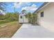 View of shed on concrete pad in grassy yard next to home at 4477 Shady Ln, Punta Gorda, FL 33980