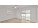 Bedroom with wood-look floors, fresh white walls, ceiling fan, updated lighting and view of the Florida room at 4477 Shady Ln, Punta Gorda, FL 33980