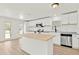 Spacious kitchen featuring white cabinets, stainless steel appliances, a butcher block island, and granite countertops at 4477 Shady Ln, Punta Gorda, FL 33980
