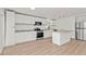 Bright kitchen featuring white cabinets, granite counters, stainless steel appliances, and a butcher block island at 4477 Shady Ln, Punta Gorda, FL 33980