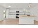 Updated kitchen featuring white cabinets, granite counters, stainless steel appliances, and a butcher block island at 4477 Shady Ln, Punta Gorda, FL 33980