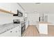 Bright kitchen with white cabinets, granite countertops, stainless steel appliances, and a butcher block island at 4477 Shady Ln, Punta Gorda, FL 33980