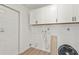 Laundry room featuring white cabinets and space for washer and dryer at 4477 Shady Ln, Punta Gorda, FL 33980