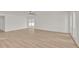 Large living room featuring wood-look floors, fresh white walls, sliding glass doors to Florida room and updated lighting at 4477 Shady Ln, Punta Gorda, FL 33980