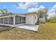 Enclosed lanai next to a concrete patio and building with white exterior at 4477 Shady Ln, Punta Gorda, FL 33980