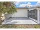 Concrete patio next to an enclosed lanai with a large palm at 4477 Shady Ln, Punta Gorda, FL 33980
