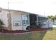 Cozy backyard featuring a fenced in pool, mulch, and screened in porch at 474 Elm Nw Ave, Port Charlotte, FL 33952