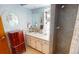 Bathroom with a vanity, mirror, tiled shower and a classic wooden jewelry box that adds elegance to the space at 474 Elm Nw Ave, Port Charlotte, FL 33952