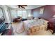 Primary bedroom with bay window and ceiling fan, offering generous natural light at 474 Elm Nw Ave, Port Charlotte, FL 33952