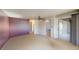 A bright, empty bedroom with two open doorways and a ceiling fan at 474 Elm Nw Ave, Port Charlotte, FL 33952