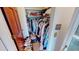 A walk-in closet with organized hanging clothes, bags on the top shelf, and shoes neatly arranged on the floor at 474 Elm Nw Ave, Port Charlotte, FL 33952