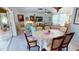 Dining area with table, chairs, ceiling fan, and view into living space at 474 Elm Nw Ave, Port Charlotte, FL 33952