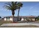Charming single-story home featuring a spacious driveway and lush landscaping at 474 Elm Nw Ave, Port Charlotte, FL 33952
