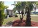 Palm trees near the house with stone accents at 474 Elm Nw Ave, Port Charlotte, FL 33952