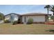 Home with a well-manicured lawn, AC unit and stone accents at 474 Elm Nw Ave, Port Charlotte, FL 33952