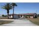 Charming single-story home with a long driveway, stone accents, and well-manicured landscaping at 474 Elm Nw Ave, Port Charlotte, FL 33952