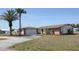 Charming single-story home with a long driveway, stone accents, and well-manicured landscaping at 474 Elm Nw Ave, Port Charlotte, FL 33952