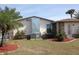 Home with a well-manicured lawn, palm trees and stone accents at 474 Elm Nw Ave, Port Charlotte, FL 33952