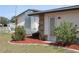 Home with a well-manicured lawn, AC unit and stone accents at 474 Elm Nw Ave, Port Charlotte, FL 33952