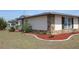 Charming home featuring stone accents and a well-maintained lawn at 474 Elm Nw Ave, Port Charlotte, FL 33952