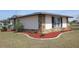 Charming home featuring stone accents and a well-maintained lawn at 474 Elm Nw Ave, Port Charlotte, FL 33952