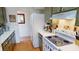 Bright kitchen with white appliances, and wood cabinets, offering a practical layout and design at 474 Elm Nw Ave, Port Charlotte, FL 33952