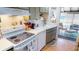 Classic kitchen featuring white appliances, and a view of the outdoor lanai at 474 Elm Nw Ave, Port Charlotte, FL 33952