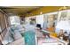 Enclosed lanai featuring an outdoor sofa, patterned rug and ceiling fan at 474 Elm Nw Ave, Port Charlotte, FL 33952