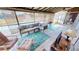 Enclosed lanai with a cushioned sofa, coffee table, patterned rug, ceiling fan and view of pool at 474 Elm Nw Ave, Port Charlotte, FL 33952