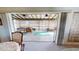 Relaxing screened-in lanai featuring comfortable seating and views of the lush backyard at 474 Elm Nw Ave, Port Charlotte, FL 33952