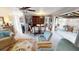 Bright living room with ceiling fan, carpet, comfortable seating, and a dining area at 474 Elm Nw Ave, Port Charlotte, FL 33952