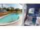 Inviting outdoor pool area with lush landscaping and a view of the screened-in lanai with comfortable seating at 474 Elm Nw Ave, Port Charlotte, FL 33952