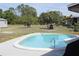 Backyard showcasing a pristine swimming pool with surrounding patio at 474 Elm Nw Ave, Port Charlotte, FL 33952
