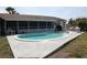 Enjoy the kidney-shaped pool with an extended concrete patio, perfect for outdoor relaxation and entertaining at 474 Elm Nw Ave, Port Charlotte, FL 33952