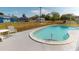 Backyard showcasing a refreshing in-ground pool with surrounding concrete patio and a secure chain-link fence at 474 Elm Nw Ave, Port Charlotte, FL 33952