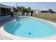 Refreshing kidney-shaped pool in a fenced-in yard, perfect for cooling off on hot days at 474 Elm Nw Ave, Port Charlotte, FL 33952